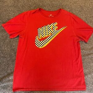Red Nike tee with checkered logo